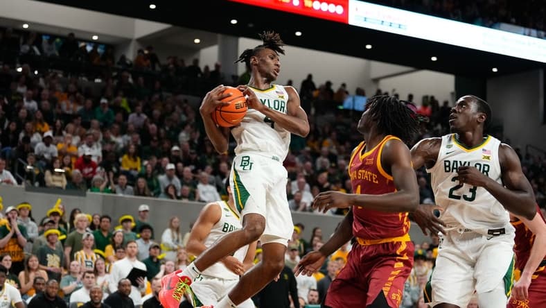Feb 3, 2024; Waco, Texas, USA; Baylor Bears guard Ja'Kobe Walter (4) grabs a rebound against the Iowa State Cyclones during the first half at Paul and Alejandra Foster Pavilion. Mandatory Credit: Chris Jones-USA TODAY Sports