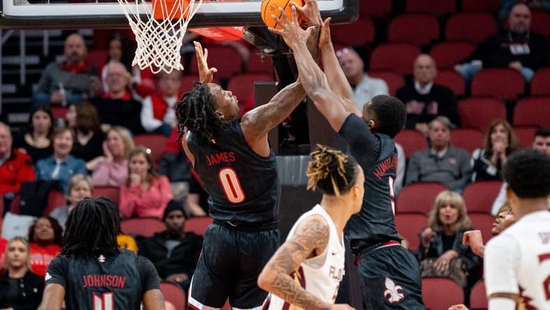Louisville Cardinals forward Brandon Huntley-Hatfield (5) and Mike James (0) grab the rebound during their game against the Florida State Seminoles on Saturday, Feb. 3, 2024 at KFC YUM Center.