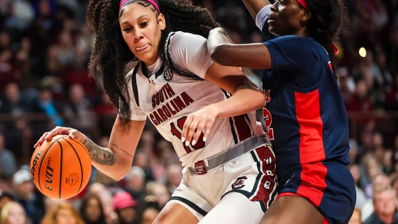 Feb 4, 2024; Columbia, South Carolina, USA; South Carolina Gamecocks center Kamilla Cardoso (10) dribbles around Ole Miss Rebels center Rita Igbokwe (32) in the first half at Colonial Life Arena. Mandatory Credit: Jeff Blake-USA TODAY Sports
