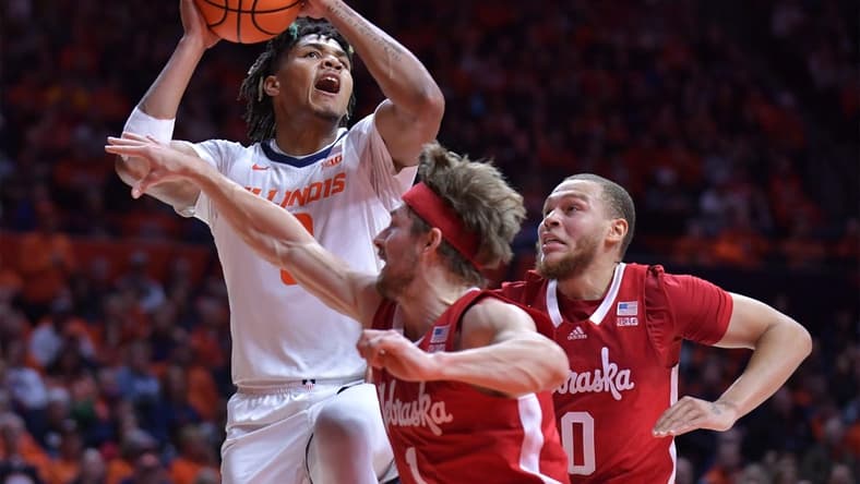 Feb 4, 2024; Champaign, Illinois, USA; Illinois Fighting Illini guard Terrence Shannon Jr. (0) drives to the basket against Nebraska Cornhuskers guard Sam Hoiberg (1) during the first half at State Farm Center. Mandatory Credit: Ron Johnson-USA TODAY Sports