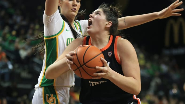 Oregon State   s Raegan Beers, right, battles Oregon   s Kennedy Basham for position under the basket during the first half at Matthew Knight Arena Sunday, Feb 4, 2024.