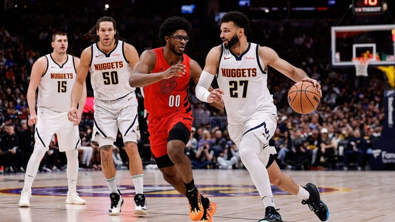 Feb 4, 2024; Denver, Colorado, USA; Denver Nuggets guard Jamal Murray (27) controls the ball against Portland Trail Blazers guard Scoot Henderson (00) as forward Aaron Gordon (50) and center Nikola Jokic (15) defend in the second quarter at Ball Arena. Mandatory Credit: Isaiah J. Downing-USA TODAY Sports