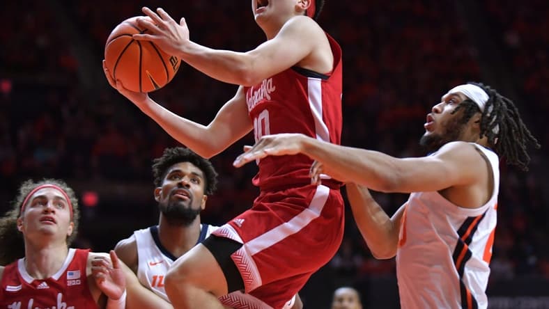 Feb 4, 2024; Champaign, Illinois, USA; Nebraska Cornhuskers guard Keisei Tominaga (30) drives past Illinois Fighting Illini forward Ty Rodgers (20) during the second half at State Farm Center. Mandatory Credit: Ron Johnson-USA TODAY Sports