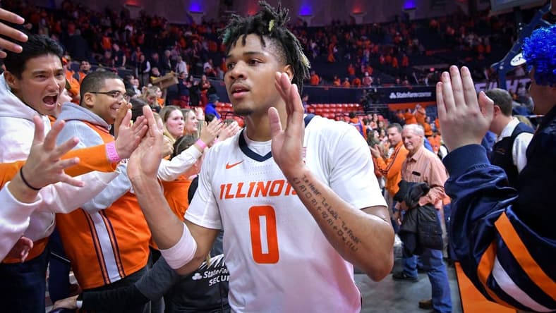 Feb 4, 2024; Champaign, Illinois, USA; Illinois Fighting Illini forward Ty Rodgers (20) gets a hand from the fans after a 87-84 win over the Nebraska Cornhuskers at State Farm Center. Mandatory Credit: Ron Johnson-USA TODAY Sports
