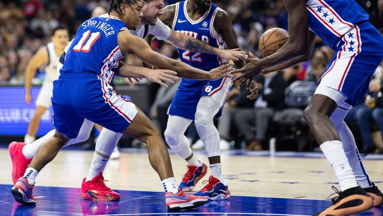 Feb 5, 2024; Philadelphia, Pennsylvania, USA; Dallas Mavericks guard Luka Doncic (77) and Philadelphia 76ers guard Jaden Springer (11) and guard Patrick Beverley (22) chase a loose ball during the second quarter at Wells Fargo Center. Mandatory Credit: Bill Streicher-USA TODAY Sports
