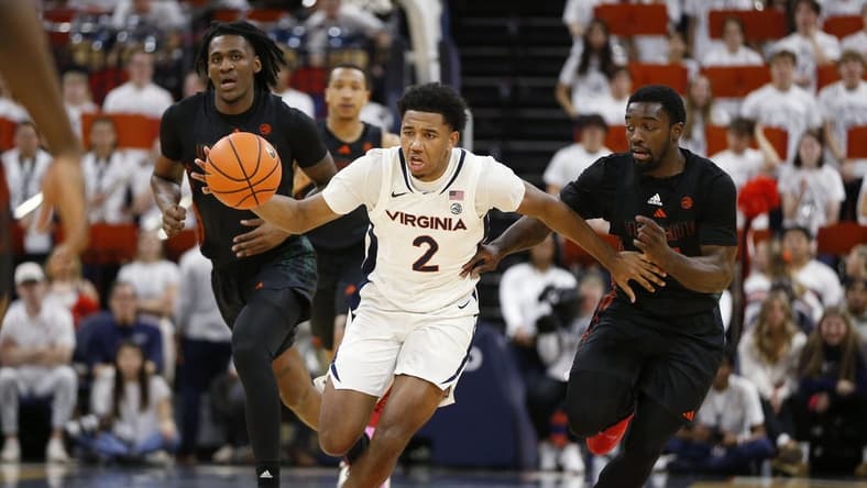 Feb 5, 2024; Charlottesville, Virginia, USA; Virginia Cavaliers guard Reece Beekman (2) dribbles the ball away from Miami (Fl) Hurricanes guard Bensley Joseph (4) during the second half at John Paul Jones Arena. Mandatory Credit: Amber Searls-USA TODAY Sports