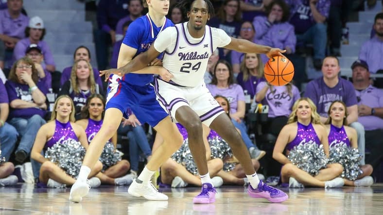 Feb 5, 2024; Manhattan, Kansas, USA; Kansas State Wildcats forward Arthur Maluma (24) is guarded by Kansas Jayhawks guard Johnny Furphy (10) during the second half at Bramlage Coliseum. Mandatory Credit: Scott Sewell-USA TODAY Sports