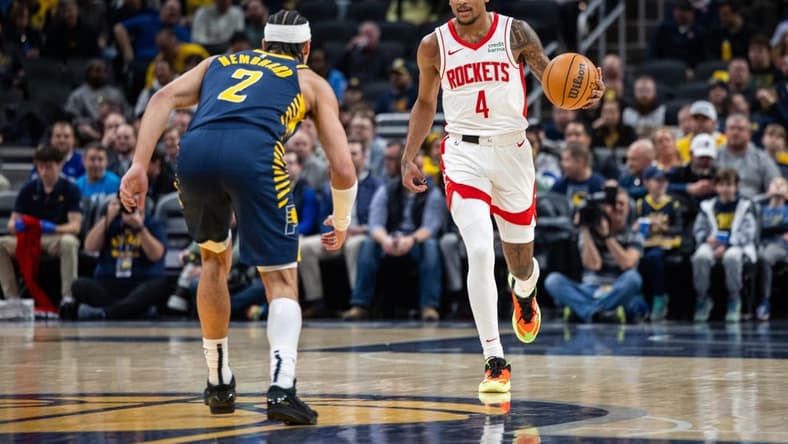 Feb 6, 2024; Indianapolis, Indiana, USA; Houston Rockets guard Jalen Green (4) dribbles the ball while Indiana Pacers guard Andrew Nembhard (2) defends in the first half at Gainbridge Fieldhouse. Mandatory Credit: Trevor Ruszkowski-USA TODAY Sports