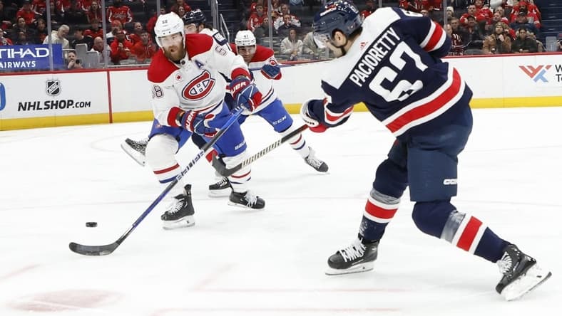 Feb 6, 2024; Washington, District of Columbia, USA; Washington Capitals left wing Max Pacioretty (67) shoots the puck as Montreal Canadiens defenseman David Savard (58) defends in the first period at Capital One Arena. Mandatory Credit: Geoff Burke-USA TODAY Sports