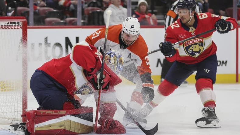 Feb 6, 2024; Sunrise, Florida, USA; Florida Panthers goaltender Anthony Stolarz (41) controls the puck after a shot by Philadelphia Flyers center Scott Laughton (21) during the first period at Amerant Bank Arena. Mandatory Credit: Sam Navarro-USA TODAY Sports