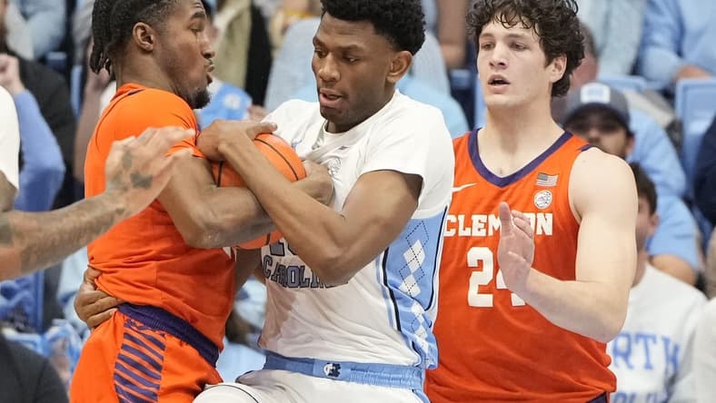Feb 6, 2024; Chapel Hill, North Carolina, USA; North Carolina Tar Heels forward Jalen Washington (13) and Clemson Tigers forward Chauncey Wiggins (21) and Clemson Tigers center PJ Hall (24) fight for the ball in the first half at Dean E. Smith Center. Mandatory Credit: Bob Donnan-USA TODAY Sports