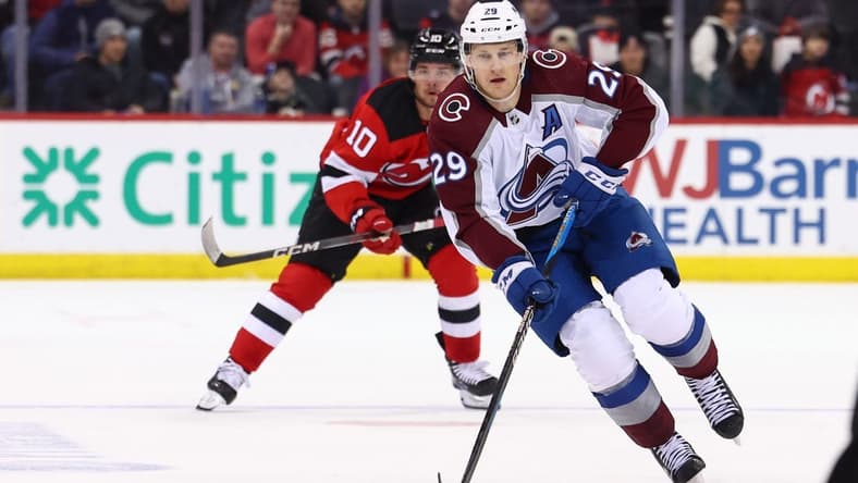 Feb 6, 2024; Newark, New Jersey, USA; Colorado Avalanche center Nathan MacKinnon (29) skates with the puck against the New Jersey Devils during the first period at Prudential Center. Mandatory Credit: Ed Mulholland-USA TODAY Sports