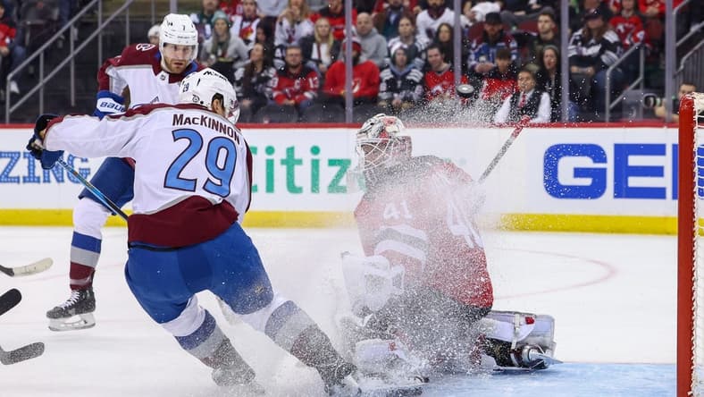 Feb 6, 2024; Newark, New Jersey, USA; New Jersey Devils goaltender Vitek Vanecek (41) makes a save on Colorado Avalanche center Nathan MacKinnon (29) during the first period at Prudential Center. Mandatory Credit: Ed Mulholland-USA TODAY Sports