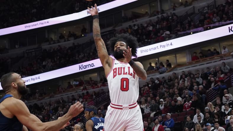 Feb 6, 2024; Chicago, Illinois, USA; Chicago Bulls guard Coby White (0) shoots over Minnesota Timberwolves center Rudy Gobert (27) during the first quarter at United Center. Mandatory Credit: David Banks-USA TODAY Sports