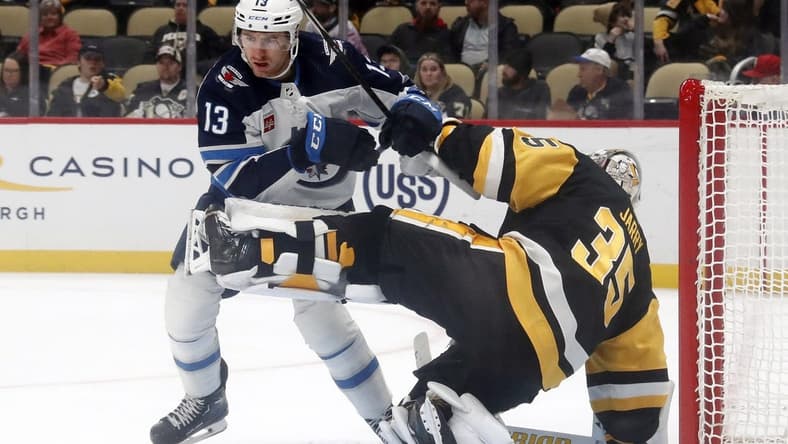 Feb 6, 2024; Pittsburgh, Pennsylvania, USA; Winnipeg Jets center Gabriel Vilardi (13) breaks free after being held by Pittsburgh Penguins goaltender Tristan Jarry (35) during the second period at PPG Paints Arena. Mandatory Credit: Charles LeClaire-USA TODAY Sports