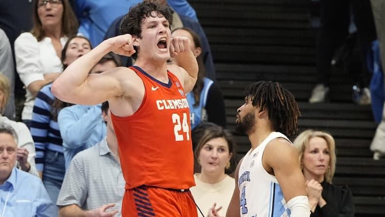 Feb 6, 2024; Chapel Hill, North Carolina, USA; Clemson Tigers center PJ Hall (24) and North Carolina Tar Heels guard RJ Davis (4) react in the second half at Dean E. Smith Center. Mandatory Credit: Bob Donnan-USA TODAY Sports