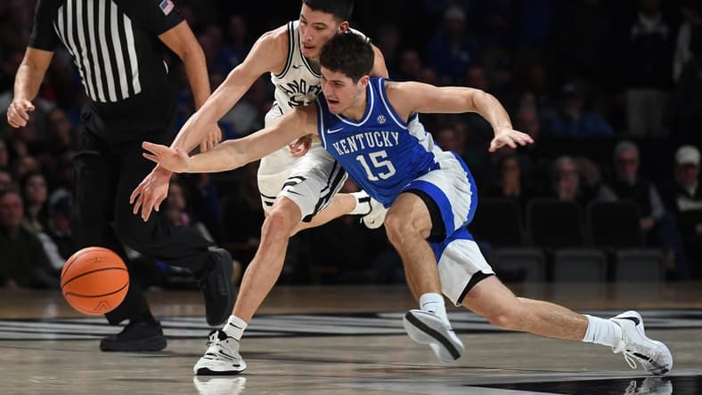 Feb 6, 2024; Nashville, Tennessee, USA; Vanderbilt Commodores guard Jason Rivera-Torres (23) and Kentucky Wildcats guard Reed Sheppard (15) battle for a loose ball during the first half at Memorial Gymnasium. Mandatory Credit: Christopher Hanewinckel-USA TODAY Sports