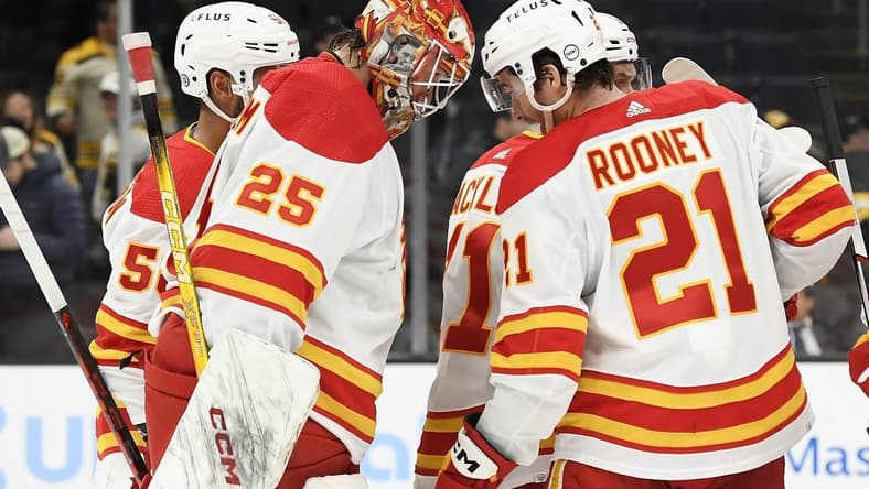 Feb 6, 2024; Boston, Massachusetts, USA; Calgary Flames goaltender Jacob Markstrom (25) and center Kevin Rooney (21) butt heads after defeating the Boston Bruins at TD Garden. Mandatory Credit: Bob DeChiara-USA TODAY Sports