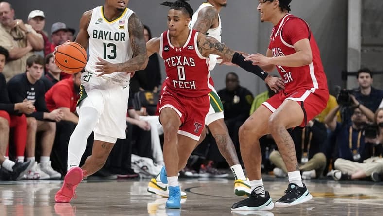 Feb 6, 2024; Waco, Texas, USA; Baylor Bears guard Langston Love (13) dribbles around Texas Tech Red Raiders guard Chance McMillian (0) during the first half at Paul and Alejandra Foster Pavilion. Mandatory Credit: Raymond Carlin III-USA TODAY Sports