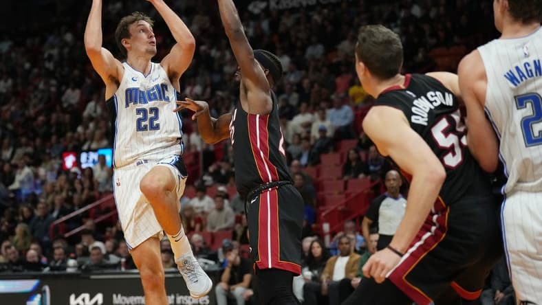 Feb 6, 2024; Miami, Florida, USA; Orlando Magic forward Franz Wagner (22) goes up for a shot over Miami Heat forward Jimmy Butler (22) during the second half at Kaseya Center. Mandatory Credit: Jim Rassol-USA TODAY Sports
