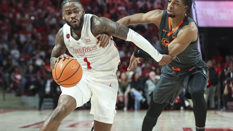Feb 6, 2024; Houston, Texas, USA; Houston Cougars guard Jamal Shead (1) drives with the ball as Oklahoma State Cowboys guard Jarius Hicklen (4) defends during the second half at Fertitta Center. Mandatory Credit: Troy Taormina-USA TODAY Sports