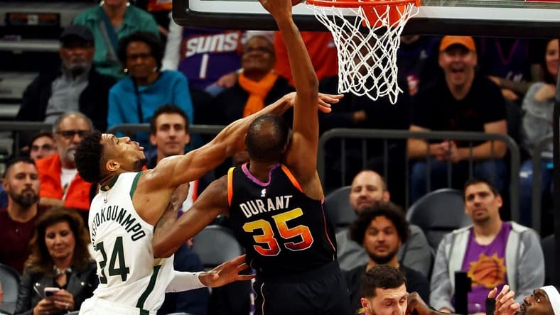 Feb 6, 2024; Phoenix, Arizona, USA; Phoenix Suns forward Kevin Durant (35) shoots the ball against Milwaukee Bucks forward Giannis Antetokounmpo (34) during the fourth quarter at Footprint Center. Mandatory Credit: Mark J. Rebilas-USA TODAY Sports