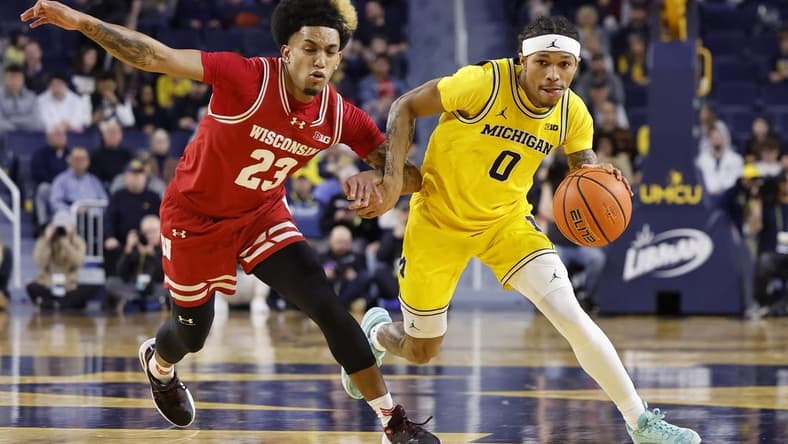 Feb 7, 2024; Ann Arbor, Michigan, USA;  Michigan Wolverines guard Dug McDaniel (0) dnr on Wisconsin Badgers guard Chucky Hepburn (23) in the first half at Crisler Center. Mandatory Credit: Rick Osentoski-USA TODAY Sports