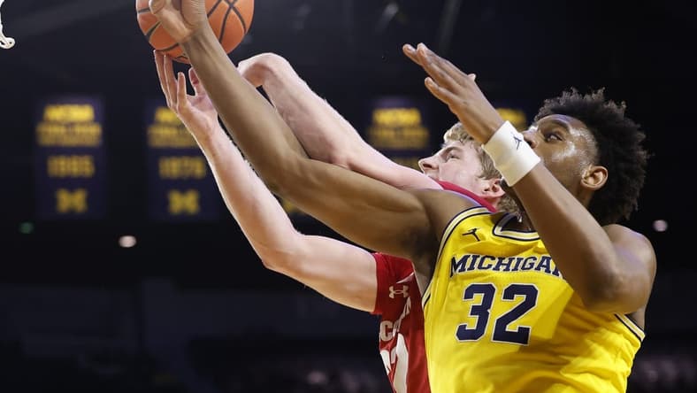 Feb 7, 2024; Ann Arbor, Michigan, USA; Wisconsin Badgers forward Steven Crowl (22) and Michigan Wolverines forward Tarris Reed Jr. (32) go for the rebound in the first half at Crisler Center. Mandatory Credit: Rick Osentoski-USA TODAY Sports