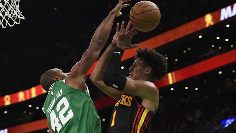 Feb 7, 2024; Boston, Massachusetts, USA; Boston Celtics center Al Horford (42) blocks the shot of Atlanta Hawks forward Jalen Johnson (1) during the first half at TD Garden. Mandatory Credit: Bob DeChiara-USA TODAY Sports