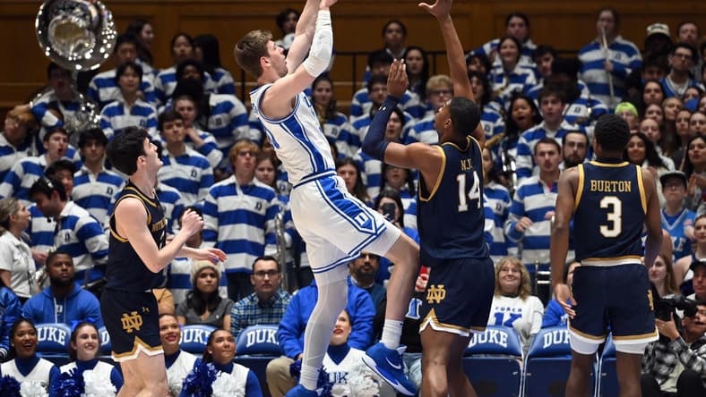 Feb 7, 2024; Durham, North Carolina, USA;  Duke Blue Devils center Kyle Filipowski (30) shoots over Notre Dame Fighting Irish forwar Kebba Nije (14) during the first half at Cameron Indoor Stadium. Mandatory Credit: Rob Kinnan-USA TODAY Sports