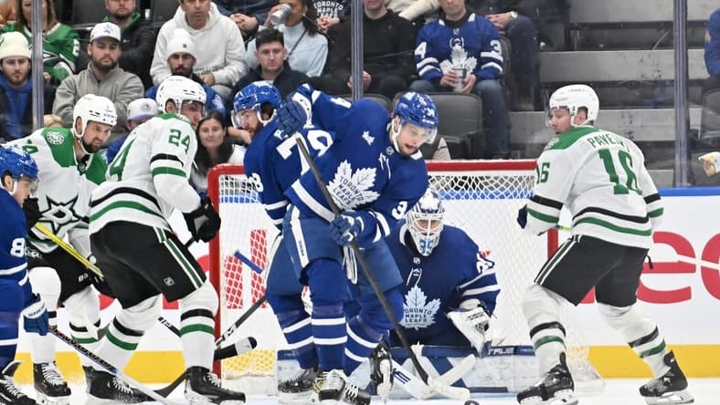 Feb 7, 2024; Toronto, Ontario, CAN; Toronto Maple Leafs forward Auston Matthews (34) clears the puck away from goalie Ilya Samsonov (35) as Dallas Stars forwards Joe Pavelski (16) and Roope Hintz (24) look on in the third period at Scotiabank Arena. Mandatory Credit: Dan Hamilton-USA TODAY Sports