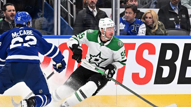 Feb 7, 2024; Toronto, Ontario, CAN; Dallas Stars forward Matt Duchene (95) turns with the puck away from Toronto Maple Leafs defenseman Jake McCabe (22) in the second period at Scotiabank Arena. Mandatory Credit: Dan Hamilton-USA TODAY Sports