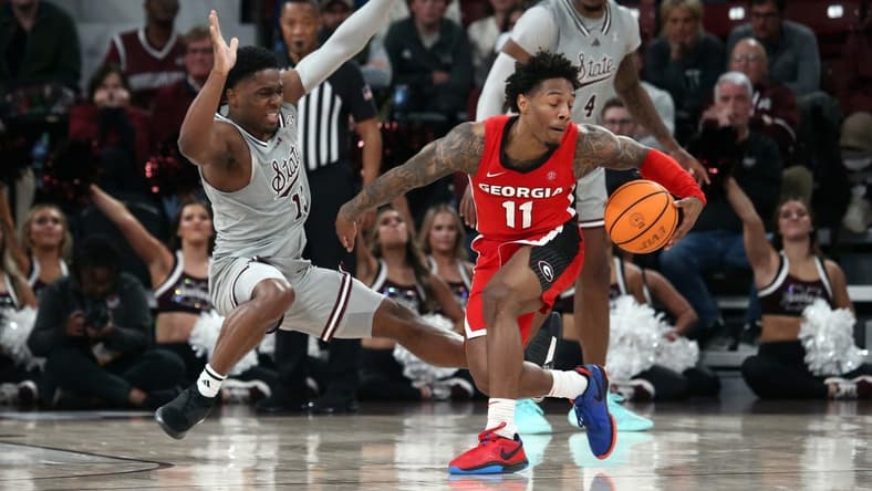 Feb 7, 2024; Starkville, Mississippi, USA; Georgia Bulldogs guard Justin Hill (11) dribbles as Mississippi State Bulldogs guard Josh Hubbard (13) defends during the second half at Humphrey Coliseum. Mandatory Credit: Petre Thomas-USA TODAY Sports