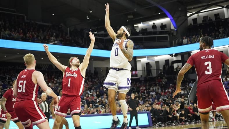Feb 7, 2024; Evanston, Illinois, USA; Northwestern Wildcats guard Boo Buie (0) shoots over Nebraska Cornhuskers guard Sam Hoiberg (1) during the second half at Welsh-Ryan Arena. Mandatory Credit: David Banks-USA TODAY Sports