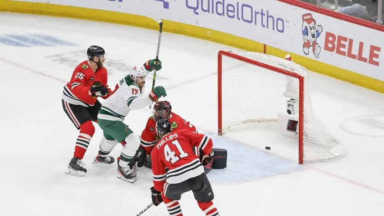Feb 7, 2024; Chicago, Illinois, USA; Minnesota Wild left wing Marcus Foligno (17) celebrates after scoring against Chicago Blackhawks goaltender Petr Mrazek (34) during the third period at United Center. Mandatory Credit: Kamil Krzaczynski-USA TODAY Sports