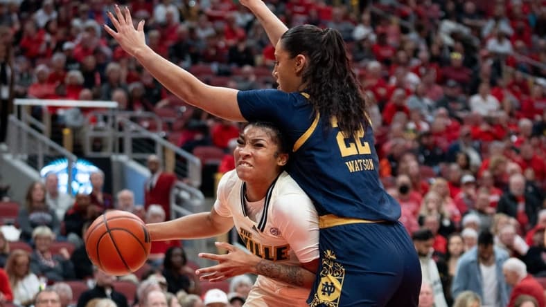 Louisville Cardinals forward Nyla Harris (2) attempts to get around Notre Dame Fighting Irish forward Kylee Watson (22) for a layup during their game on Thursday, Feb. 8, 2024 at KFC YUM Center.
