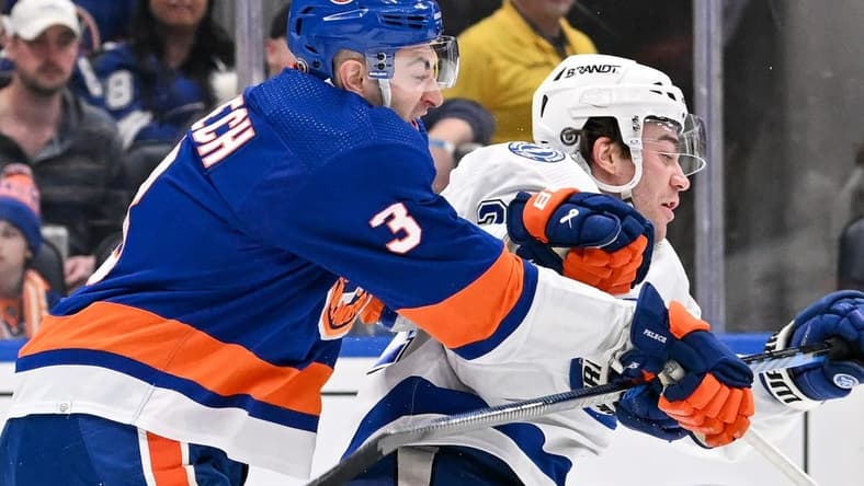 Feb 8, 2024; Elmont, New York, USA; New York Islanders defenseman Adam Pelech (3) checks Tampa Bay Lightning center Brayden Point (21) during the first period at UBS Arena. Mandatory Credit: Dennis Schneidler-USA TODAY Sports