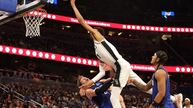 Feb 8, 2024; Orlando, Florida, USA; Orlando Magic center Moritz Wagner (21) fouls San Antonio Spurs center Victor Wembanyama (1) during the second half at Kia Center. Mandatory Credit: Kim Klement Neitzel-USA TODAY Sports