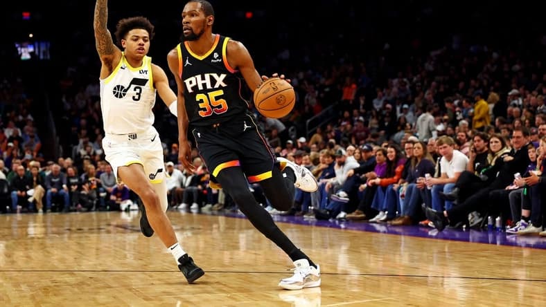 Feb 8, 2024; Phoenix, Arizona, USA; Phoenix Suns forward Kevin Durant (35) drives to the basket against Utah Jazz guard Keyonte George (3) during the third quarter at Footprint Center. Mandatory Credit: Mark J. Rebilas-USA TODAY Sports