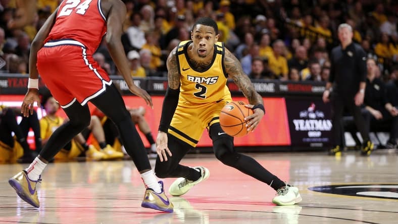 Feb 9, 2024; Richmond, Virginia, USA; Virginia Commonwealth Rams guard Zeb Jackson (2) dribbles the ball as Dayton Flyers guard Kobe Elvis (24) defends during the first half at Stuart C. Siegel Center. Mandatory Credit: Amber Searls-USA TODAY Sports