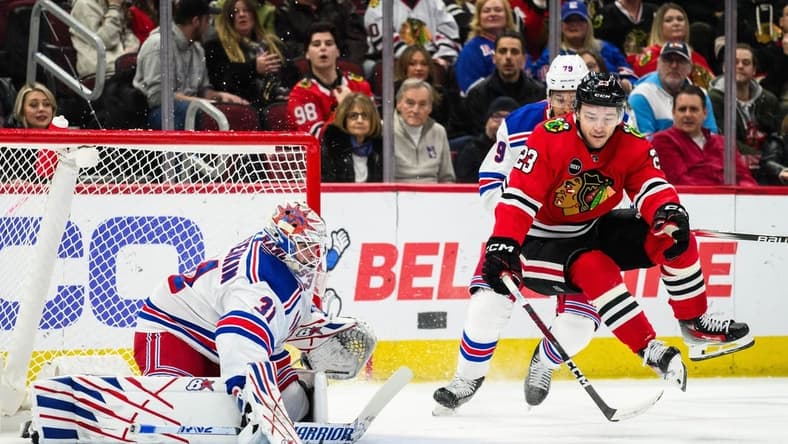 Feb 9, 2024; Chicago, Illinois, USA; Chicago Blackhawks center Philipp Kurashev (23) jumps off the ice as New York Rangers goaltender Igor Shesterkin (31) defends his goal during the first period at the United Center. Mandatory Credit: Daniel Bartel-USA TODAY Sports