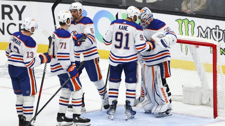 Feb 9, 2024; Anaheim, California, USA; Edmonton Oilers left wing Evander Kane (91) and goaltender Calvin Pickard (30) celebrate after the Edmonton Oilers defeat the Anaheim Ducks at Honda Center. Mandatory Credit: Jessica Alcheh-USA TODAY Sports