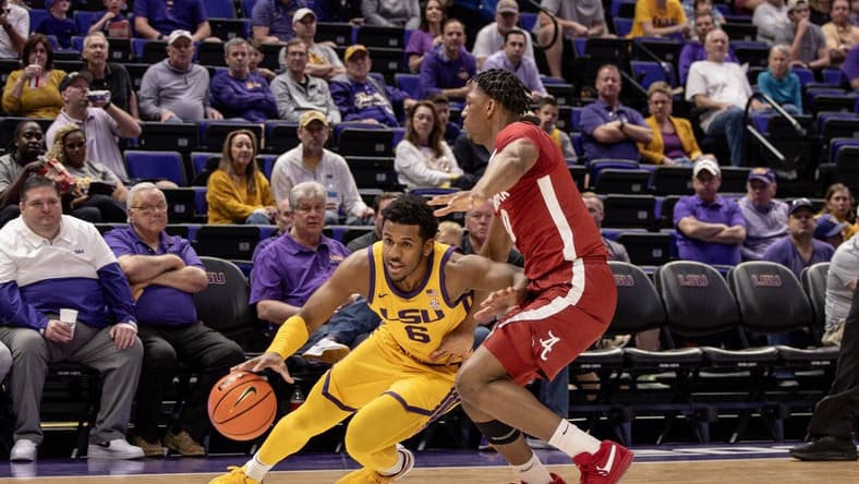 Feb 10, 2024; Baton Rouge, Louisiana, USA;  LSU Tigers guard Jordan Wright (6) dribbles the ball against Alabama Crimson Tide forward Mouhamed Dioubate (10) during the first half at Pete Maravich Assembly Center. Mandatory Credit: Stephen Lew-USA TODAY Sports