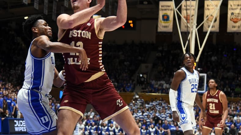 Feb 10, 2024; Durham, North Carolina, USA; Boston College Eagles center Quinten Post (12) shoots the ball over Duke Blue Devils guard Jeremy Roach (left) during the first half at Cameron Indoor Stadium. Mandatory Credit: Rob Kinnan-USA TODAY Sports