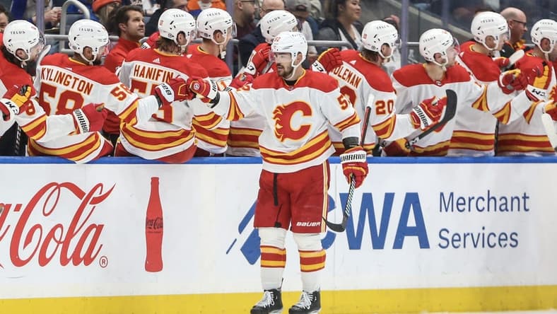 Feb 10, 2024; Elmont, New York, USA;  Calgary Flames defenseman MacKenzie Weegar (52) celebrates with his teammates after scoring a goal in the second period New York Islanders at UBS Arena. Mandatory Credit: Wendell Cruz-USA TODAY Sports
