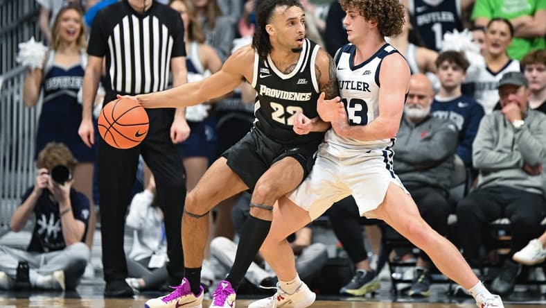 Feb 10, 2024; Indianapolis, Indiana, USA;  Providence Friars guard Devin Carter (22) dribbles against Butler Bulldogs guard Finley Bizjack (13) during the first half at Hinkle Fieldhouse. Mandatory Credit: Robert Goddin-USA TODAY Sports