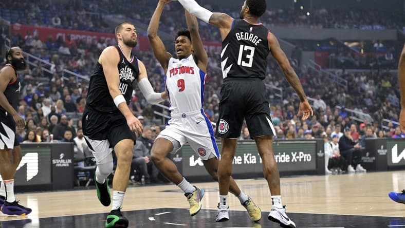 Feb 10, 2024; Los Angeles, California, USA;  Detroit Pistons forward Ausar Thompson (9) is defended by Los Angeles Clippers center Ivica Zubac (40) and forward Paul George (13) as he drives to the basket in the first half at Crypto.com Arena. Mandatory Credit: Jayne Kamin-Oncea-USA TODAY Sports