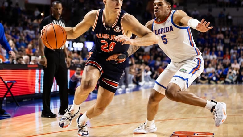 Feb 10, 2024; Gainesville, Florida, USA; Auburn Tigers guard Lior Berman (24) drives to the basket against Florida Gators guard Will Richard (5) during the first half at Exactech Arena at the Stephen C. O'Connell Center. Mandatory Credit: Matt Pendleton-USA TODAY Sports