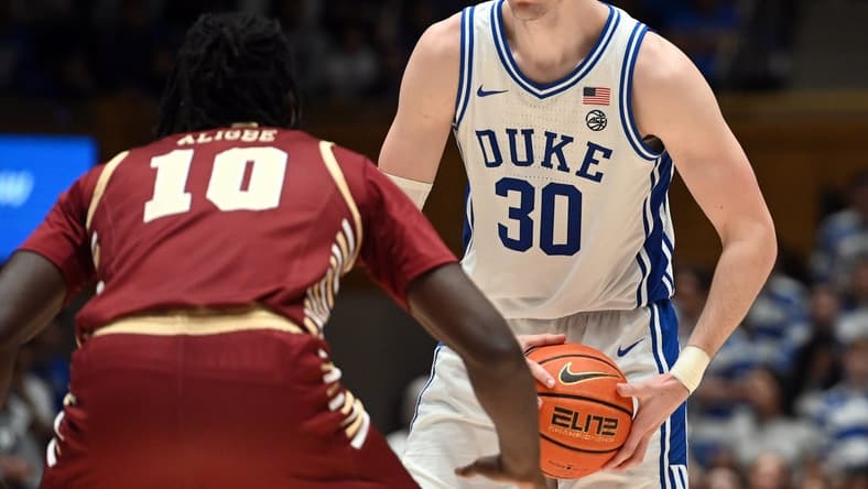 Feb 10, 2024; Durham, North Carolina, USA; Duke Blue Devils center Kyle Filipowski (30) controls the ball in front of Boston College Eagles forward Prince Aligbe (10) during the second half at Cameron Indoor Stadium. Mandatory Credit: Rob Kinnan-USA TODAY Sports