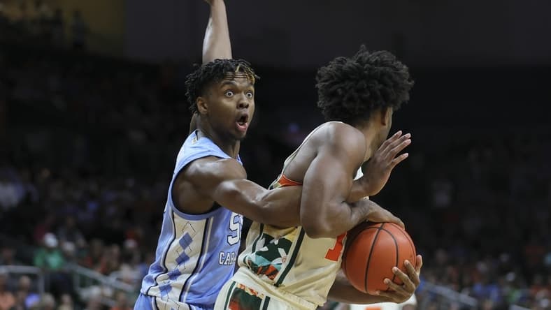 Feb 10, 2024; Coral Gables, Florida, USA; North Carolina Tar Heels forward Harrison Ingram (55) reacts as he guards Miami Hurricanes forward Norchad Omier (15) during the first half at Watsco Center. Mandatory Credit: Sam Navarro-USA TODAY Sports